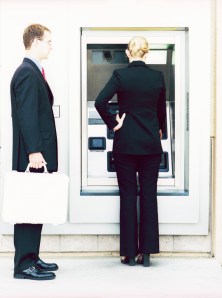 Businessman Waiting to Use Cash Machine